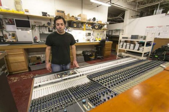 Vintage King Audio technician Jeff Spatafora looks over a refurbished Neve 8078 audio mixer at its warehouse in Ferndale. Vintage King specializes in providing vintage equipment to studios across the country. / Jarrad Henderson/Detroit Free Press