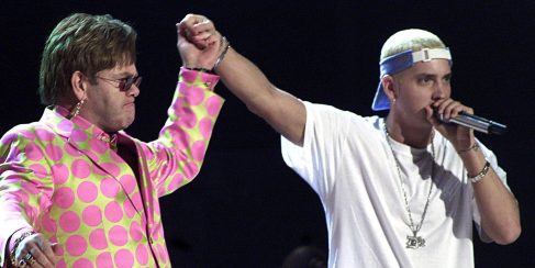 LOS ANGELES, UNITED STATES: Elton John (L) joins rap musician Eminem (R) during their much anticipated performance at the 43rd Annual Grammy Awards 21 February 2001 at the Staples Center in Los Angeles. The controversial rapper Eminem won three Grammys despite anger over his lyrics, which critics revile as misogynist, anti-gay and violent. AFP PHOTO/Hector MATA (Photo credit should read HECTOR MATA/AFP/Getty Images)