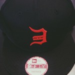 AUTOGRAPHED LIMITED EDITION DETROIT TRIBUTE BASEBALL HAT Every cap is personally signed by Eminem Limited edition Snapback Hat, no longer available anywhere else Backwards “E” stitched in red on the front and center of the cap Cap also features a subtle surprise on the back panels – two middle fingers stitched in black just above the snap fasteners