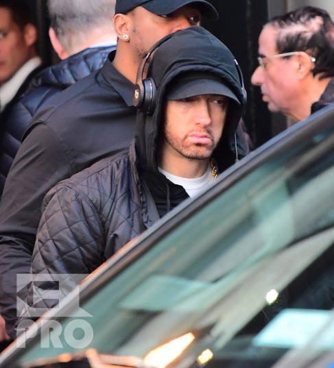 EXCLUSIVE: Eminem is notorious for his low-key lifestyle, so seeing him in public in NYC on Thursday was extremely rare. The rapper went incognito in a jacket, hoodie and baseball cap as he left a hotel in Manhattan surrounded by security guards. His face could be seen under his cap, and he appeared to be extremely tired, as he headed to an early morning rehearsal for Saturday Night Live.