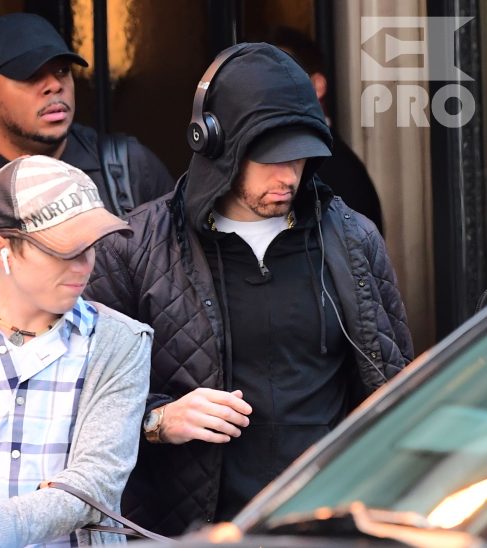 EXCLUSIVE: Eminem is notorious for his low-key lifestyle, so seeing him in public in NYC on Thursday was extremely rare. The rapper went incognito in a jacket, hoodie and baseball cap as he left a hotel in Manhattan surrounded by security guards. His face could be seen under his cap, and he appeared to be extremely tired, as he headed to an early morning rehearsal for Saturday Night Live.