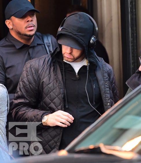 EXCLUSIVE: Eminem is notorious for his low-key lifestyle, so seeing him in public in NYC on Thursday was extremely rare. The rapper went incognito in a jacket, hoodie and baseball cap as he left a hotel in Manhattan surrounded by security guards. His face could be seen under his cap, and he appeared to be extremely tired, as he headed to an early morning rehearsal for Saturday Night Live.