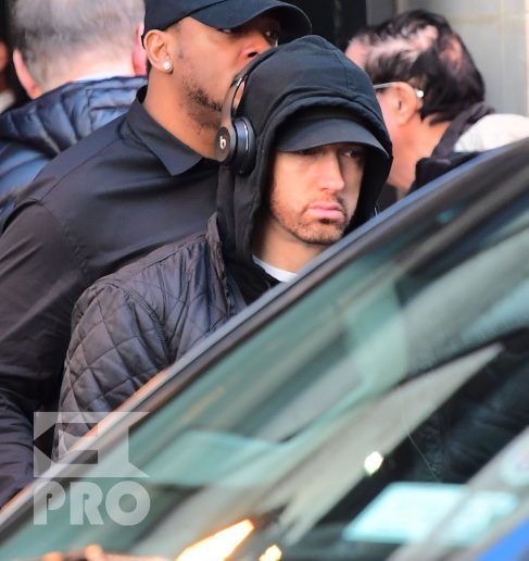 EXCLUSIVE: Eminem is notorious for his low-key lifestyle, so seeing him in public in NYC on Thursday was extremely rare. The rapper went incognito in a jacket, hoodie and baseball cap as he left a hotel in Manhattan surrounded by security guards. His face could be seen under his cap, and he appeared to be extremely tired, as he headed to an early morning rehearsal for Saturday Night Live.