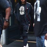 New York, NY - *EXCLUSIVE* - Eminem quickly heads to his car after leaving his hotel. Eminem doesn't have the time to stop and talk to fans as he waves instead and hops into his ride.