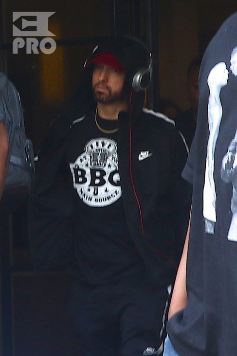 New York, NY - *EXCLUSIVE* - Eminem quickly heads to his car after leaving his hotel. Eminem doesn't have the time to stop and talk to fans as he waves instead and hops into his ride.