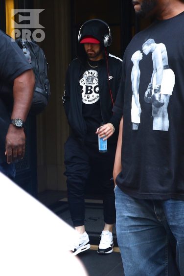New York, NY - *EXCLUSIVE* - Eminem quickly heads to his car after leaving his hotel. Eminem doesn't have the time to stop and talk to fans as he waves instead and hops into his ride.