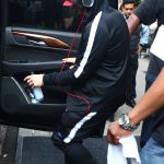 New York, NY - *EXCLUSIVE* - Eminem quickly heads to his car after leaving his hotel. Eminem doesn't have the time to stop and talk to fans as he waves instead and hops into his ride.