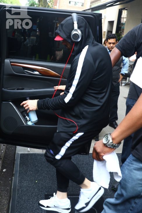 New York, NY - *EXCLUSIVE* - Eminem quickly heads to his car after leaving his hotel. Eminem doesn't have the time to stop and talk to fans as he waves instead and hops into his ride.