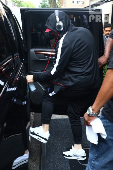 New York, NY - *EXCLUSIVE* - Eminem quickly heads to his car after leaving his hotel. Eminem doesn't have the time to stop and talk to fans as he waves instead and hops into his ride.