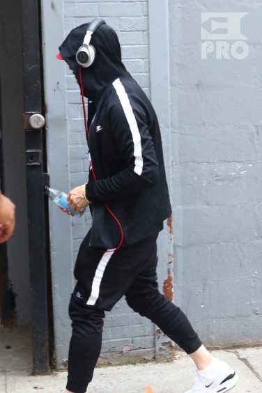 New York, NY - *EXCLUSIVE* - Eminem quickly heads to his car after leaving his hotel. Eminem doesn't have the time to stop and talk to fans as he waves instead and hops into his ride.