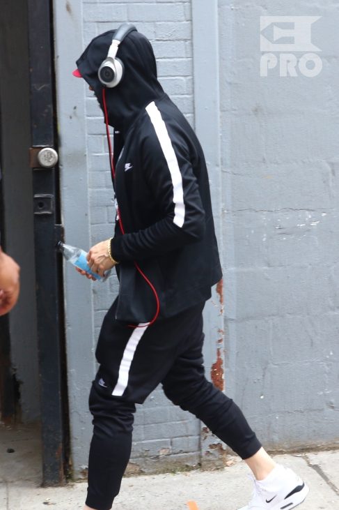 New York, NY - *EXCLUSIVE* - Eminem quickly heads to his car after leaving his hotel. Eminem doesn't have the time to stop and talk to fans as he waves instead and hops into his ride.