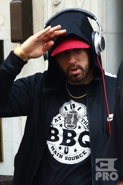 New York, NY - *EXCLUSIVE* - Eminem quickly heads to his car after leaving his hotel. Eminem doesn't have the time to stop and talk to fans as he waves instead and hops into his ride.