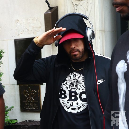 New York, NY - *EXCLUSIVE* - Eminem quickly heads to his car after leaving his hotel. Eminem doesn't have the time to stop and talk to fans as he waves instead and hops into his ride.